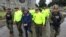 FILE - This undated photo released by Colombia's National Police shows officers escorting a man whom police identified as Ecuadorean drug trafficker Washington Edison Prado after his April 2017 arrest on an indictment by a Florida federal court. Colombia’s chief prosecutor’s office said Feb. 24. 2018, that it had extradited Prado to the United States.