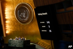 The results of a vote on a resolution concerning the Ukraine are displayed during an emergency meeting of the General Assembly at United Nations headquarters in New York, March 2, 2022.