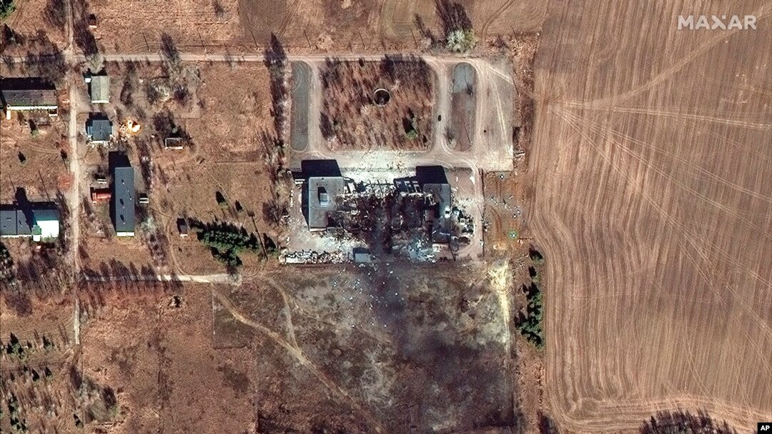 A factory and a store burn after having been bombarded in Irpin, in the outskirts of Kyiv, Ukraine, March 6, 2022. 