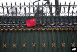 The Chinese flag is put on the fence of the Chinese embassy in Kyiv, Ukraine, March 1, 2022.