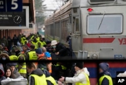Displaced persons fleeing from Ukraine crowd a platform at the train station in Przemysl, Poland, March 3, 2022.