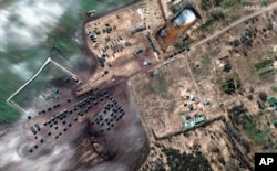 FILE - This satellite image provided by Maxar Technologies shows ground forces equipment and convoy in Khilchikha, Belarus, Feb. 28, 2022.
