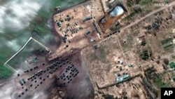 FILE - This satellite image provided by Maxar Technologies shows ground forces equipment and convoy in Khilchikha, Belarus, Feb. 28, 2022.