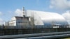 FILE - A shelter construction covers the exploded reactor at the Chernobyl nuclear plant, in Chernobyl, Ukraine, on April 27, 2021.