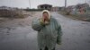 A woman cries outside houses damaged by a Russian airstrike, according to locals, in Gorenka, outside the capital Kyiv, Ukraine, March 2, 2022. 