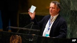 Ukrainian Ambassador to the United Nations Sergiy Kyslytsya holds up a copy of the charter of the United Nations while speaking during an emergency meeting of the General Assembly at United Nations headquarters, March 2, 2022.