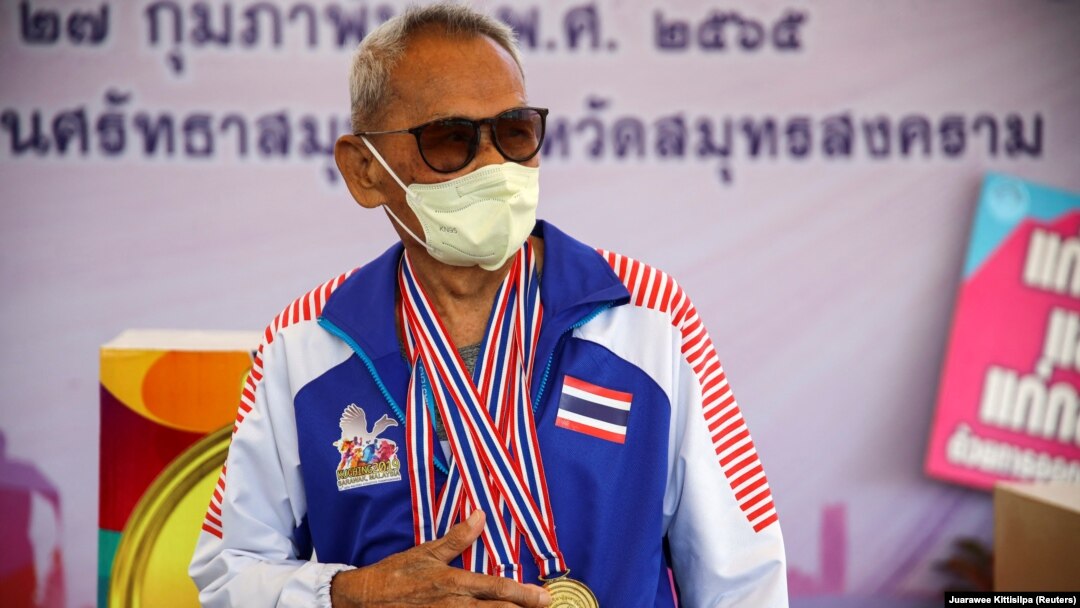 102-year-old athlete Sawang Janpram stands with his four gold medals for 100 meter sprint, javelin, discus throw, and shotput. Feb 27, 2022
