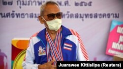 102-year-old athlete Sawang Janpram stands with his four gold medals for 100 meter sprint, javelin, discus throw, and shotput. Feb 27, 2022