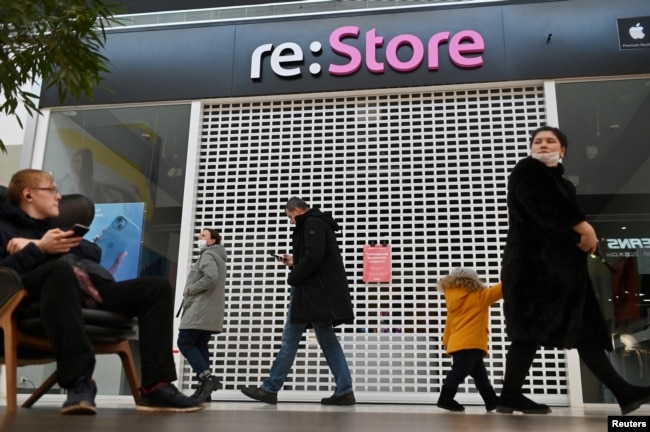 Orang-orang berjalan melewati toko Apple yang tutup di sebuah mal di Omsk, Rusia 2 Maret 2022. (Foto: REUTERS/Alexey Malgavko)
