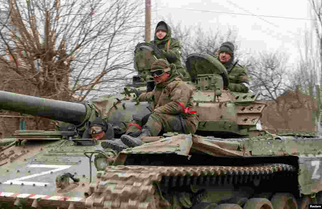 Service members of pro-Russian troops in uniforms without insignia are seen atop of a tank with the letter &quot;Z&quot; painted on its sides in the separatist-controlled settlement of Buhas (Bugas), as Russia&#39;s invasion of Ukraine continues, in the Donetsk region, Ukraine, March 1, 2022.