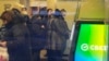FILE - People stand in line to withdraw money from an ATM in Sberbank in St. Petersburg, Russia, Feb. 25, 2022.