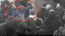 Robert Scott Palmer throws a fire extinguisher during the Jan. 6, 2021, breach of the Capitol in this image from the US Department of Justice and enhanced to highlight Palmer.