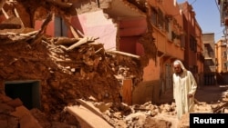 FILE - Mohamed Sebbagh, 66, stands in front of his destroyed house, in the aftermath of a deadly earthquake, in Amizmiz, Morocco, September 10, 2023.