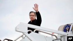 Secretary of State Antony Blinken waves as he boards a plane to depart, Thursday, March 3, 2022 at Andrews Air Force Base, Maryland.