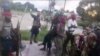 FILE - This image taken from militant video released by the Islamic State group on March 29, 2021, purports to show fighters near the strategic north eastern Mozambique town of Palma.