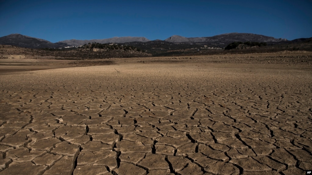 Part of the Vinuela reservoir is seen dry due to lack of rain in La Vinuela, southern Spain, Feb. 22, 2022. Declining agricultural yields and reduced water resources are key risks as global temperatures continue to rise. (AP Photo/Carlos Gil)