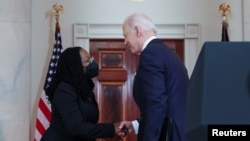 U.S. President Joe Biden shakes hands with U.S. Appeals Court Judge Ketanji Brown Jackson after announcing her as his nominee to be a U.S. Supreme Court Associate Justice, Feb. 25, 2022.