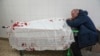 Serhii, father of teenager Iliya, cries on his son's lifeless body lying on a stretcher at a maternity hospital converted into a medical ward in Mariupol, Ukraine, March 2, 2022. 