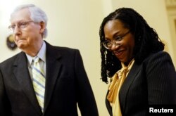 Supreme Court nominee Judge Ketanji Brown Jackson smiles as she arrives for a meeting with Senate Minority Leader Mitch McConnell (R-KY) i in Washington, March 2, 2022.