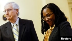 Supreme Court nominee Judge Ketanji Brown Jackson smiles as she arrives for a meeting with Senate Minority Leader Mitch McConnell (R-KY) i in Washington, March 2, 2022.