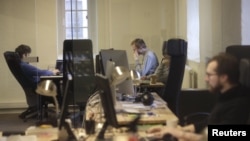 FILE - Journalists work in the independent, Russia-focused, media start-up Meduza office in Riga, March 30, 2015. "Within a few days ... it is possible that there will be no independent media left in Russia," read a statement published to Meduza's website March 3, 2022. 