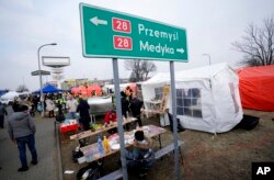 An outside kitchen and eating area is set up for displaced persons fleeing Ukraine, in Przemysl, Poland, March 3, 2022.