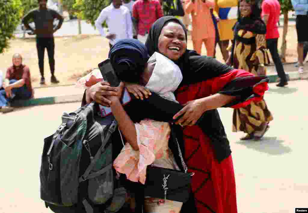 A family reacts after seeing their daughter, one of the Nigerian students who arrived from Ukraine after fleeing the Russian invasion, in Abuja, Nigeria.