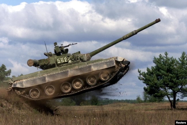 FILE - An Ukrainian T-80UD tank jumps during a show at Desna firing ground near Kyiv, Sept. 22, 2000.