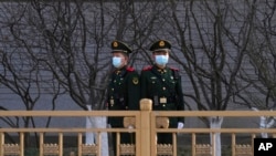 Chinese paramilitary policemen stand guard in the Tiananmen area near the Great Hall of the People ahead of the annual parliamentary meetings on March 3, 2022, in Beijing. 