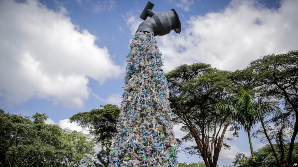 A giant art sculpture showing a tap outpouring plastic bottles, each of which was picked up in the neighborhood of Kibera, during the U.N. Environment Assembly (UNEA) held at the U.N. Environment Programme (UNEP) headquarters in Nairobi, Kenya Wednesday, March 2, 2022. 