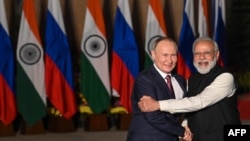 FILE - India's Prime Minister Narendra Modi, right, greets Russian President Vladimir Putin before a meeting at Hyderabad House in New Delhi, Dec. 6, 2021.