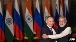 FILE - India's Prime Minister Narendra Modi, right, greets Russian President Vladimir Putin before a meeting at Hyderabad House in New Delhi, Dec. 6, 2021.