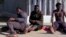 FILE: This video grab shows an injured migrant (L) after arriving with others at the Temporary Center for Immigrants and Asylum Seekers (CETI) in Melilla after jumping the border fence separating Spain's Melilla enclave from Morocco on March 2, 2022. 