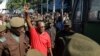 FILE - The leader of Tanzania's main opposition party, Freeman Mbowe, flashes a two-finger salute as he arrives at a court in Dar Es Salaam, Tanzania, Feb. 18, 2022. 