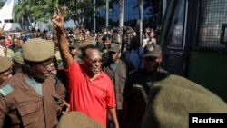 FILE - The leader of Tanzania's main opposition party, Freeman Mbowe, flashes a two-finger salute as he arrives at a court in Dar Es Salaam, Tanzania, Feb. 18, 2022. 