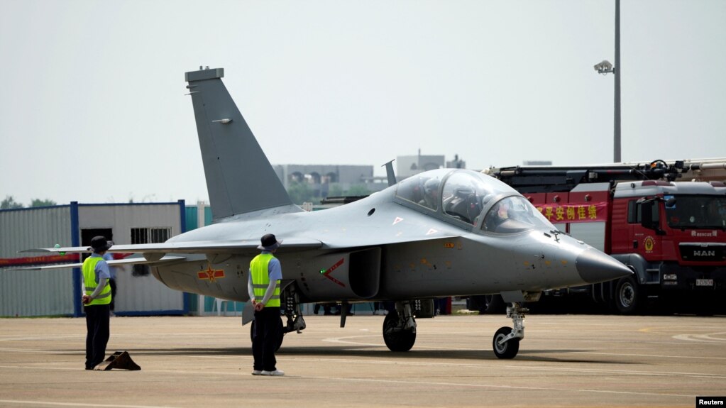 Pilots operate a JL-10 advance trainer jet of Chinese People's Liberation Army (PLA) Air Force at the China International Aviation and Aerospace Exhibition, or Airshow China, in Zhuhai, Guangdong province, China September 28, 2021. REUTERS/Aly Song