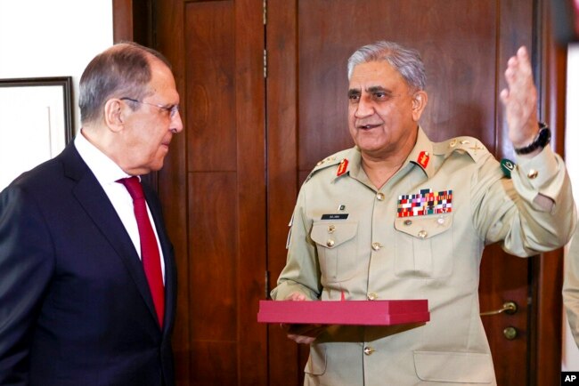 FILE - In this handout photo released by Russian Foreign Ministry Press Service, Russian Foreign Minister Sergey Lavrov, left, listens to Pakistan's Army Chief Gen. Qamar Javed Bajwa during their meeting in Islamabad, Pakistan, April 7, 2021.