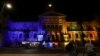 People look on as Cape Town's city hall is illuminated in the colors of the Ukrainian flag in support of Ukraine following its invasion by Russia, in Cape Town, South Africa, March 2, 2022.