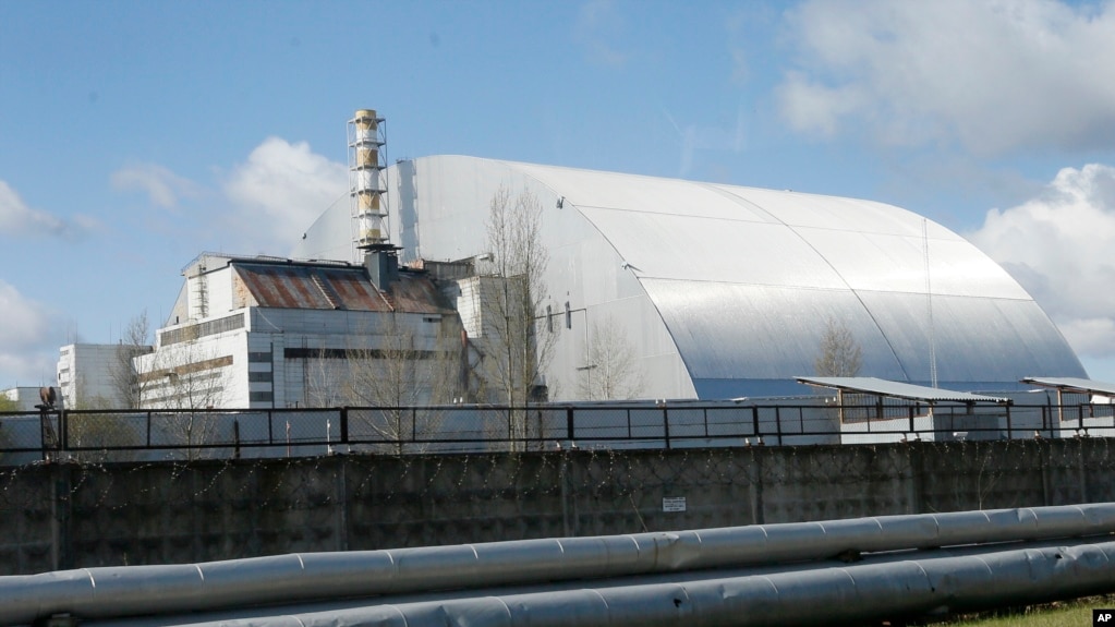 In this file photo, a shelter construction covers the exploded reactor at the Chernobyl nuclear plant, in Chernobyl, Ukraine, on April 27, 2021. (AP Photo/Efrem Lukatsky, File)