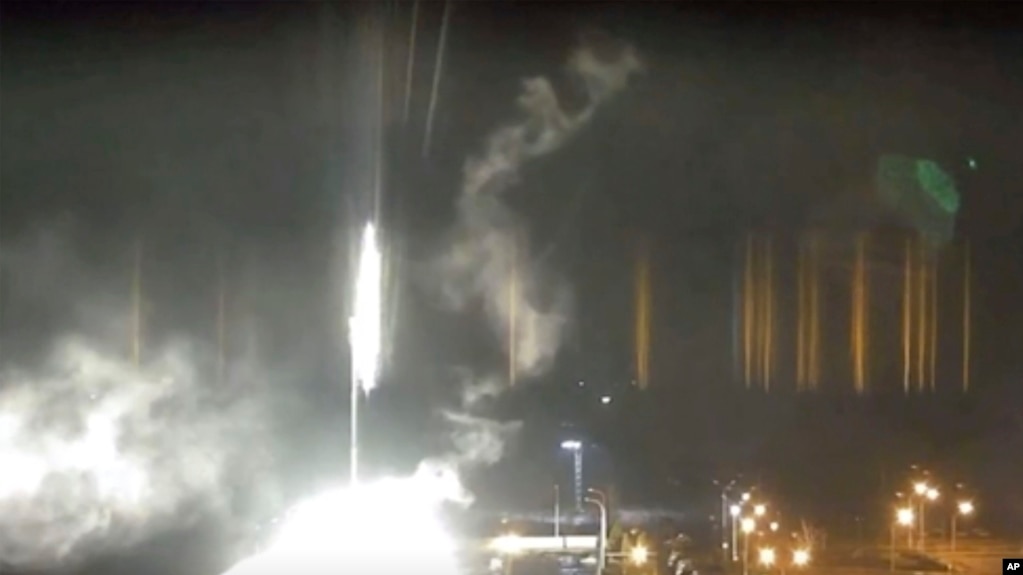 This image made from a video released by Zaporizhzhia nuclear power plant shows bright flaring object landing in grounds of the nuclear plant in Enerhodar, Ukraine Friday, March 4, 2022. (AP)