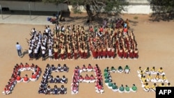 Students of Saint Joseph's High School sit in the school yard to form the word 'peace' to condemn Russia for waging a war against Ukraine, in Ranga Reddy District, India, on March 5, 2022.
