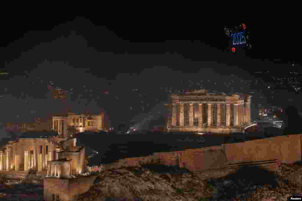 A drone view shows drones forming a "2025" next to the ancient Parthenon temple atop the Acropolis hill during New Year's celebrations, in Athens, Greece, Jan. 1, 2025. 