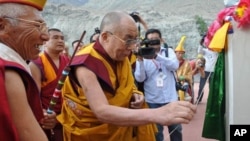 His Holiness the Dalai Lama opening the name plate of the newly installed statue of Gyalwa Jampa at Disket Monastery in Ladakh's Nubra valley, on 25 July 2010