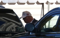 U.S. President Donald Trump enters the Presidential motorcade before traveling to an undisclosed location at the south portico of the White House in Washington, Nov. 8, 2020.