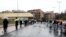 FILE - People line up in the rain outside a supermarket after the Italian island of Sicily closed them, as it tightens measures to try and contain the spread of coronavirus disease, in Catania, Italy, March 23, 2020.
