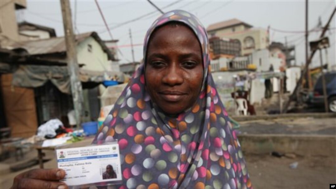 Fatima Bello display her new voters registration card in Lagos, Nigeria, Saturday, Jan. 15, 2011. An effort to register 70 million voters across Nigeria wobbled to life Saturday, as volunteers spread out across Africa's most populous nation ahead of its A