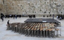 An ultra-Orthodox Jew stands past praying pulpits at the nearly deserted Western Wall, Judaism's holiest site, after Israel has imposed some of the world's tightest restrictions to contain COVID-19 coronavirus disease, in Jerusalem on March 12, 2020…