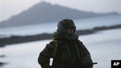 A South Korean marine mans a check point along the coast of South Korea's Yeonpyeong Island Sunday, Nov. 28, 2010.