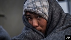 FILE - An Afghan refugee is seen at the railway station of Sid, where Serbian authorities send them to Croatia. The Taliban claims it has ceased sending threatening letters and is urging Afghans to stay home.