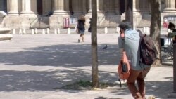 A visitor snaps a picture of Saint Sulpice church in Paris. (Lisa Bryant/VOA)